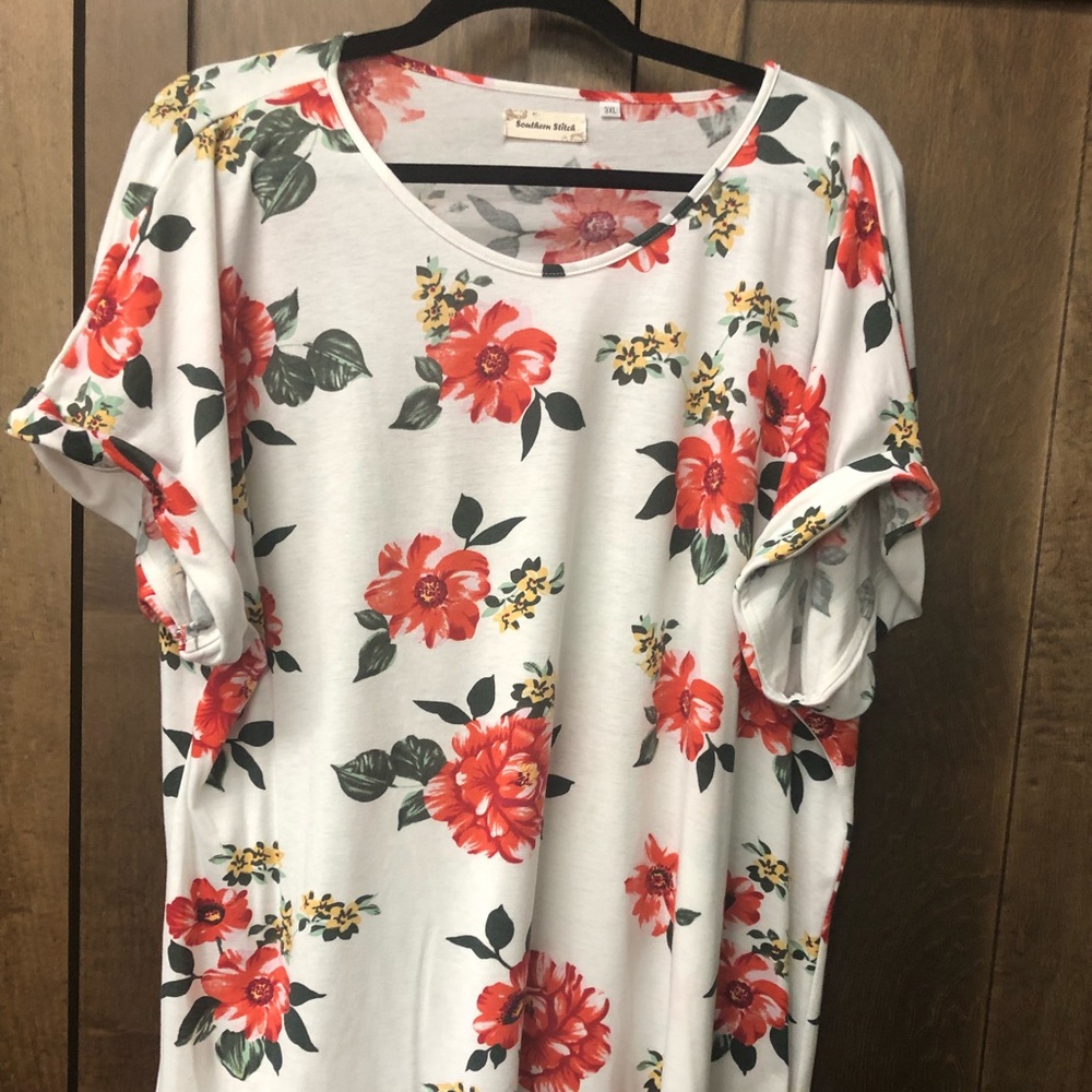 Short sleeve top with flowers. New but tags removed.